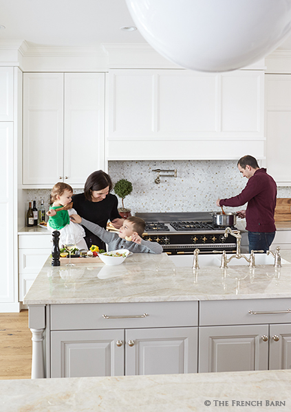 White kitchen island and chandelier