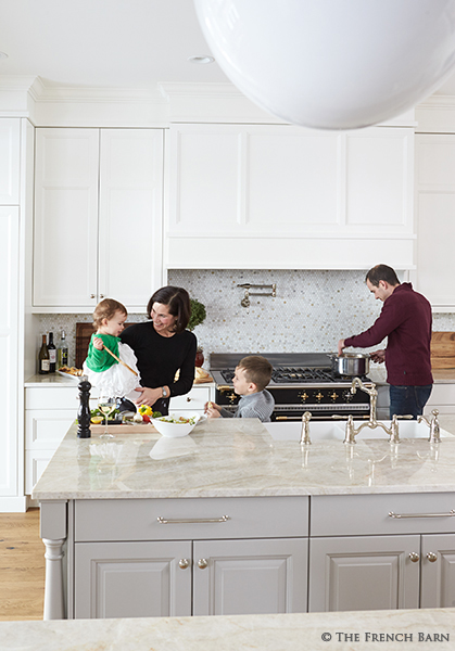 Light kitchen cabinetry surrounding a Lacanche range