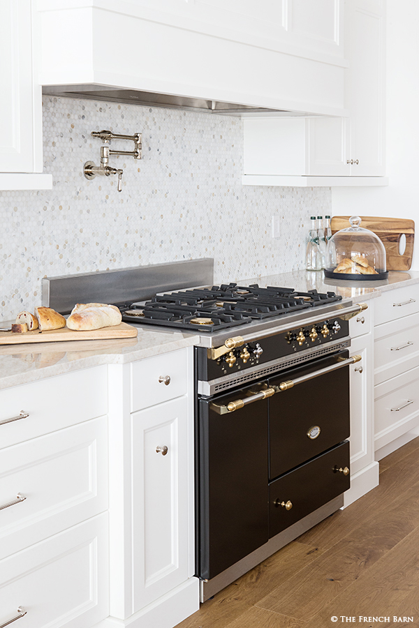 White cabinetry around Matt Black range