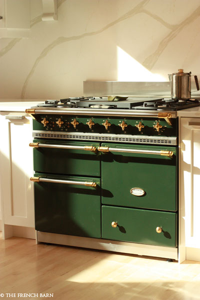 Dark Green stove in kitchen filled with light